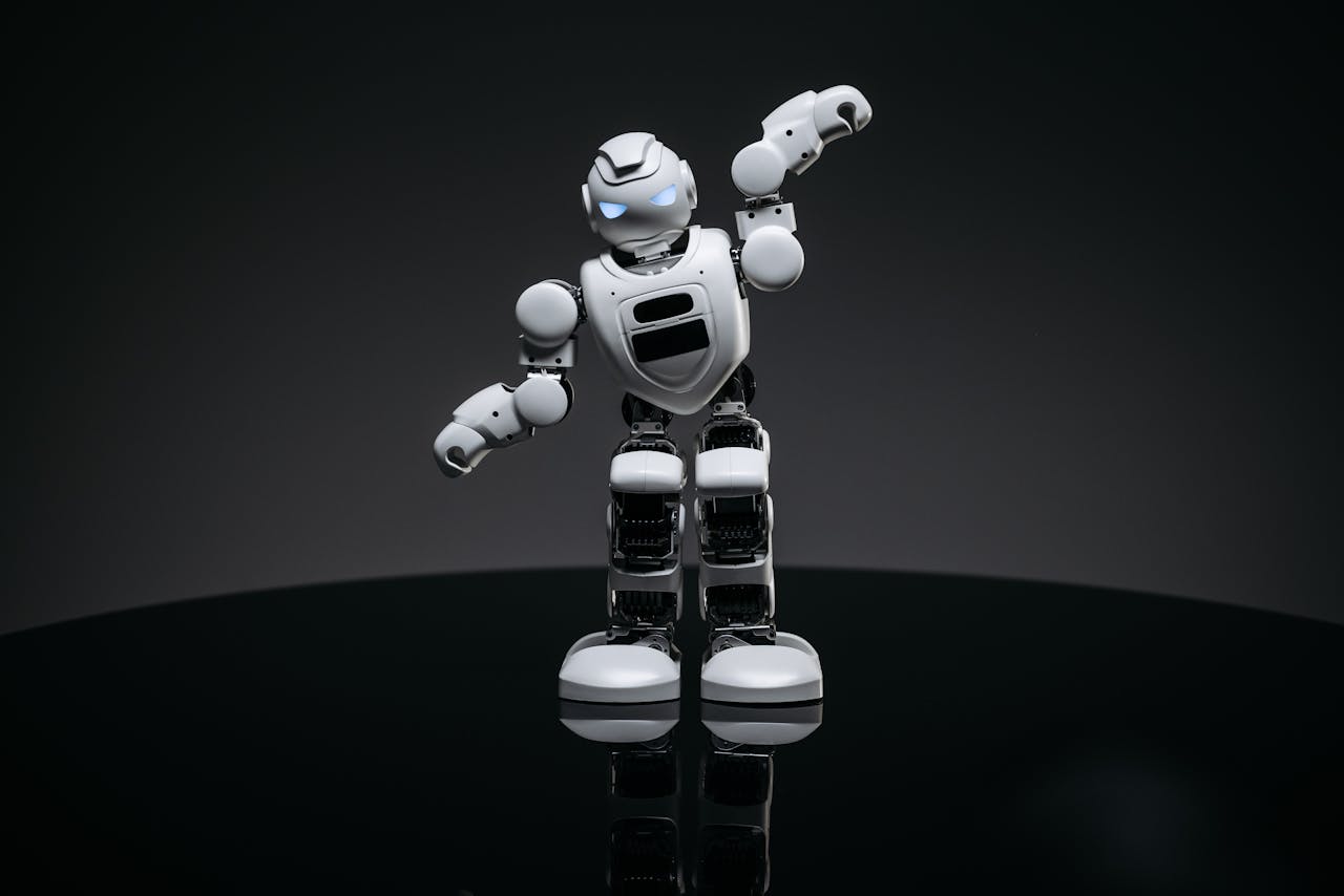 A white robot toy stands confidently in a studio setting, showcasing advanced design.